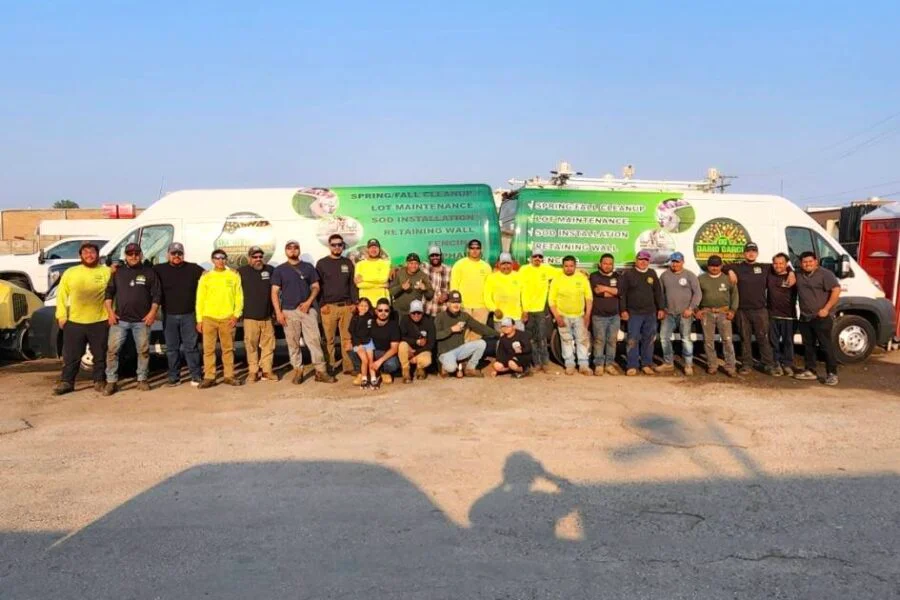 Dario Garcia Landscaping full crew in front of branded company vans